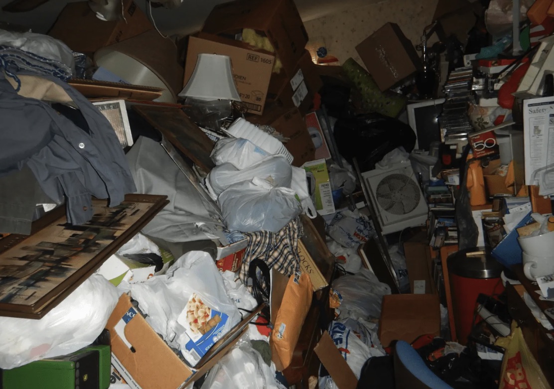 Pontiac room with heavy bags, boxes, household goods, and blocked walking space